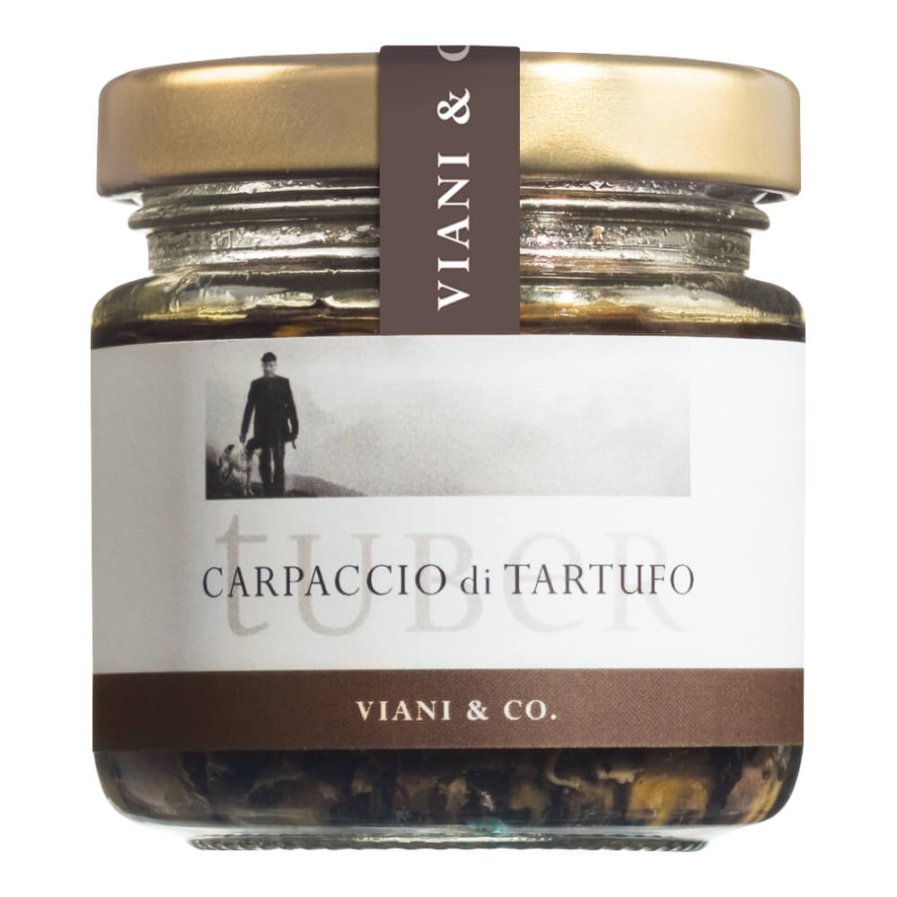 Ein 80-g-Glas von Viani & Co. Carpaccio di Tartufo - dünne Scheiben von Sommertrüffel in Trüffelsaft - mit goldenem Deckel und braunem Etikett.