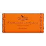 Handgefertigte 75g-Schokoladentafel von Dolci pensieri mit der Aufschrift "Vollmilchschokolade mit Vanille und Mandarinen", mit orangefarbener Umhüllung und dekorativem Rand.