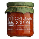 Ein 190-g-Glas mit Orto delle Dolomiti - Sugo aus frischem Gemüse von Alpe Magna, mit grünem Papierdeckel und weißem Etikett in italienischer und deutscher Sprache.