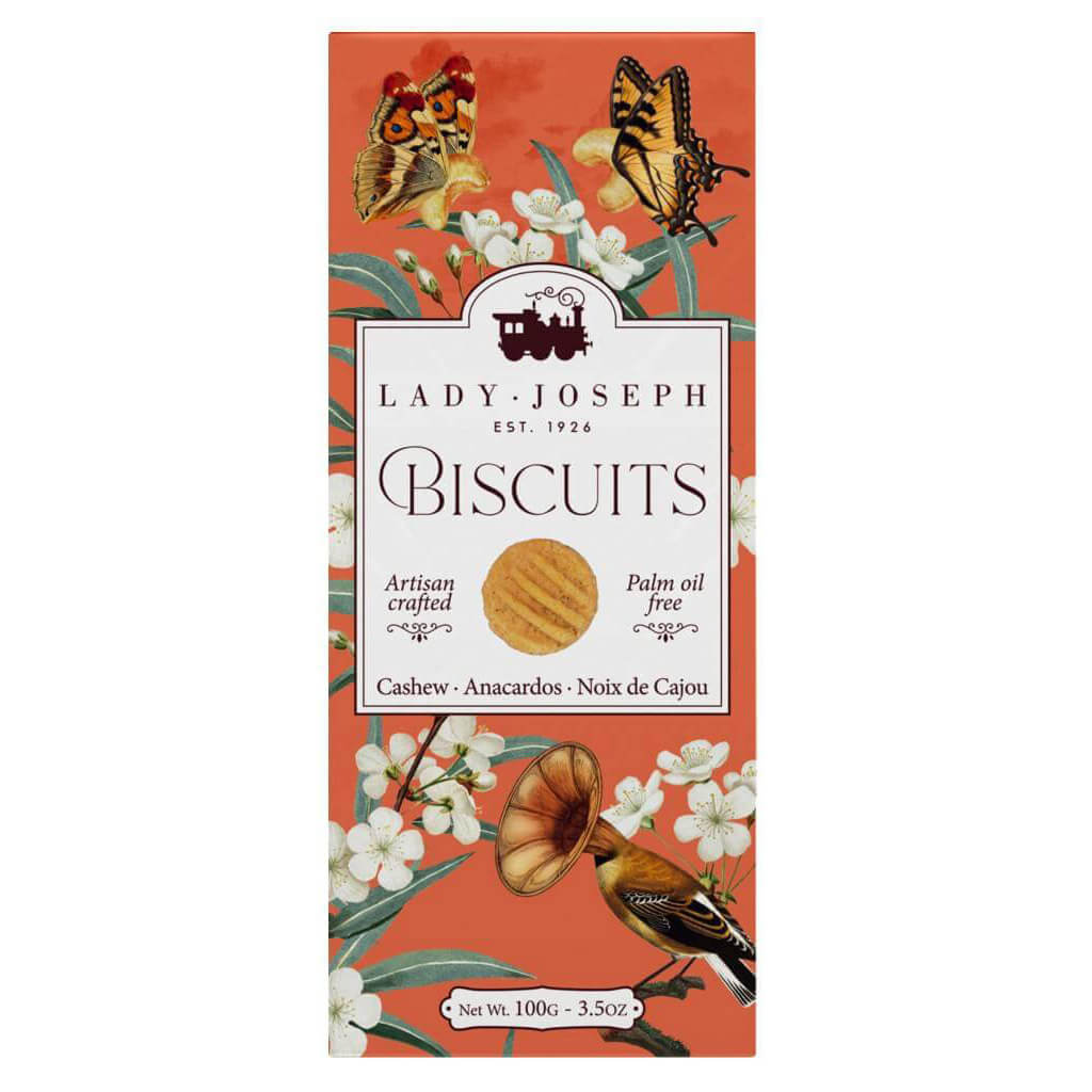 Rechteckige orangefarbene Schachtel mit Lady Joseph Cashew-Keksen (100 g) mit Blumen- und Schmetterlingsmotiven auf der Verpackung.