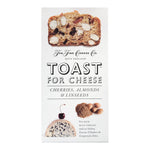The Fine Cheese Co. Toast for Cheese by Artisan Biscuits, 100g, kombiniert Kirschen, Mandeln & Leinsamen (mit Kirschen, Mandeln & Leinsamen) auf der Verpackung.