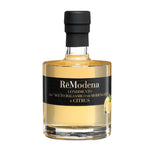 Eine 250-ml-Flasche Remodena Zitronenbalsamico aus Modena IGP mit schwarzem Etikett und Zitronenmotiv.