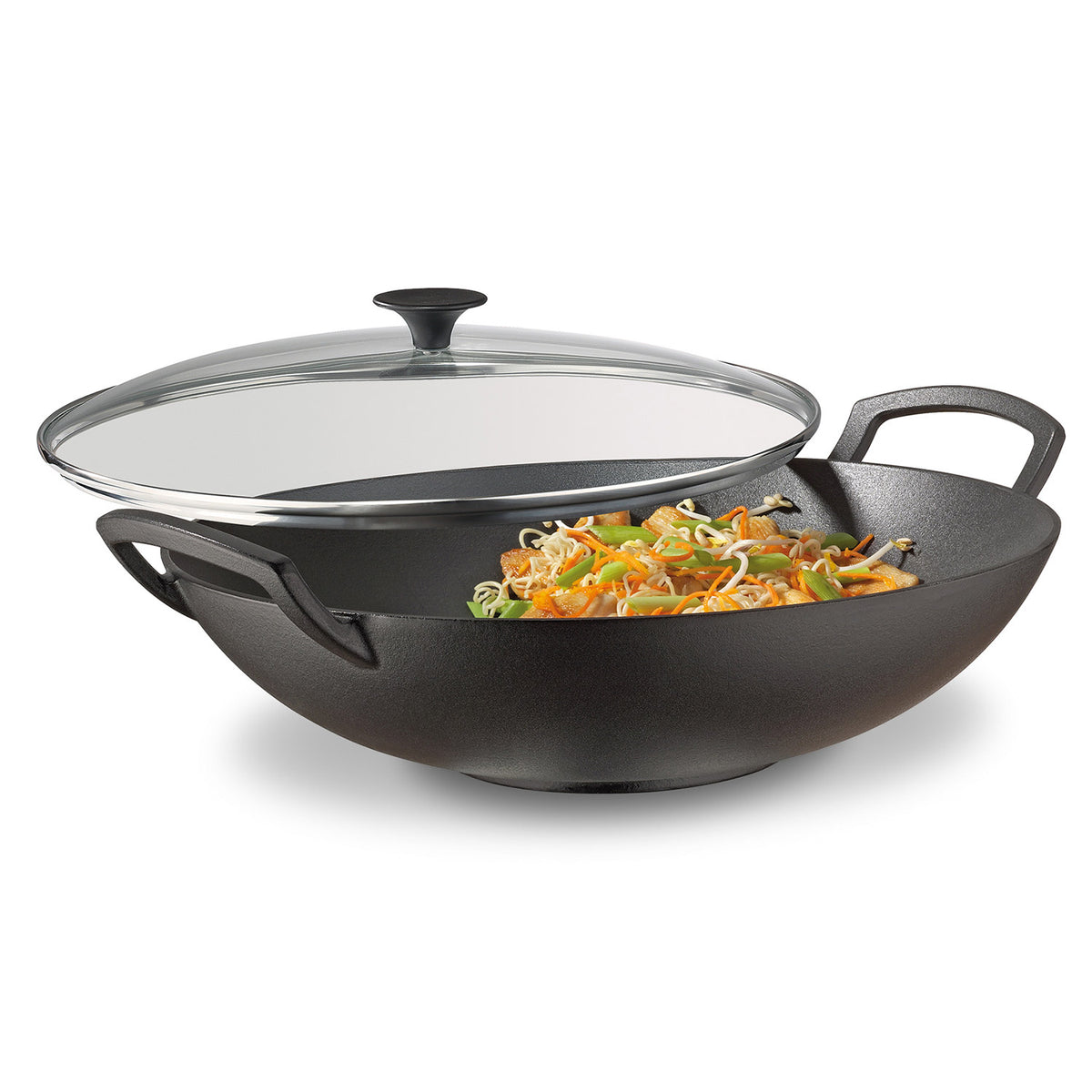 Spring Wok-Set aus Gusseisen mit Glasdeckel (Ø 35 cm) von Spring, gefüllt mit gebratenem Gemüse und Sojasprossen, auf weißem Hintergrund.