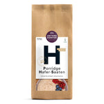Eine braune Papiertüte mit 500 g Antersdorfer Mühle Porridge Hafer-Saaten, auf deren Etikett eine Schüssel mit Porridge und Beeren abgebildet ist.